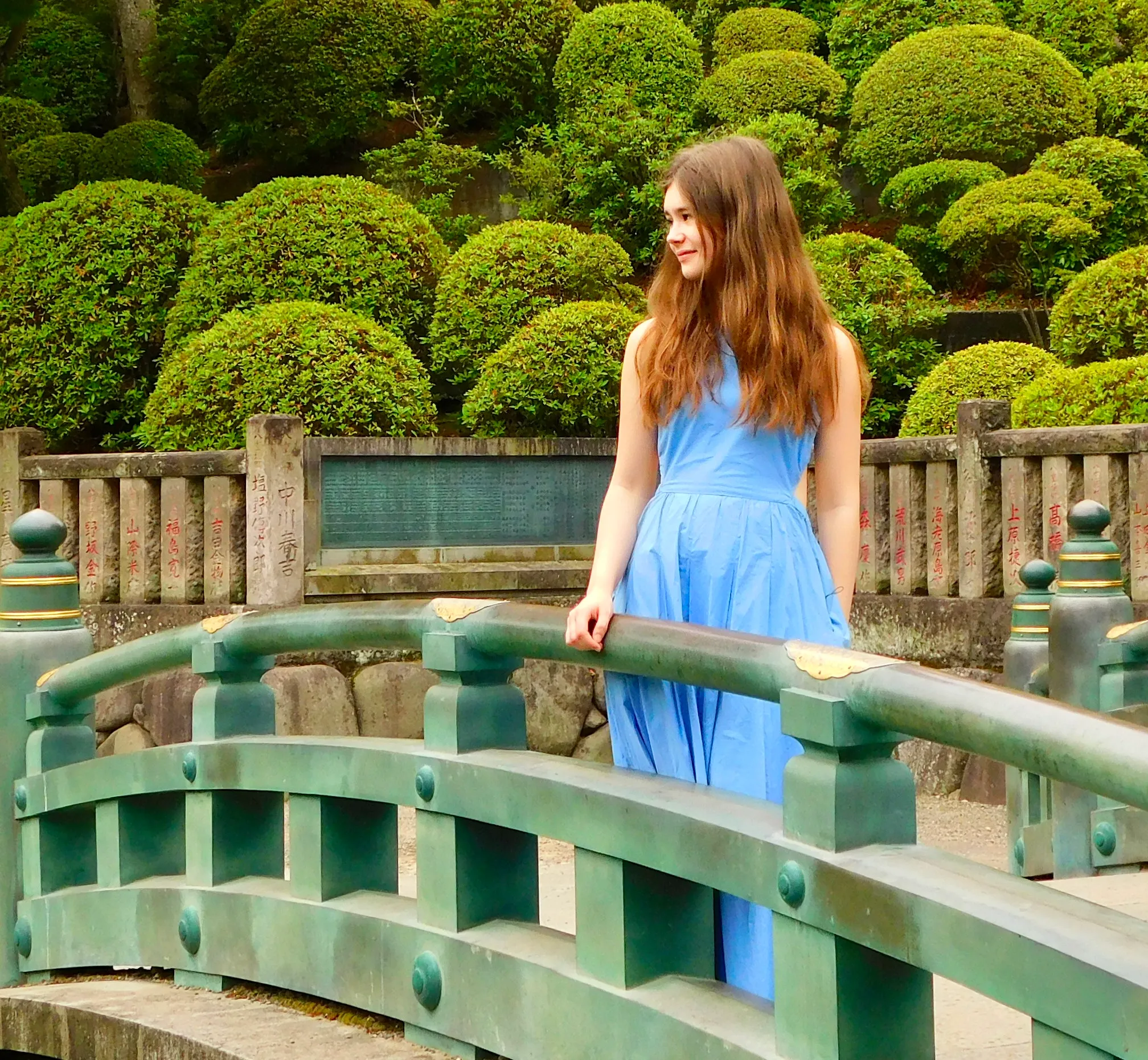 Lalie Lours (Best Teen Book Review Site) photo on a small bridge near a lake.